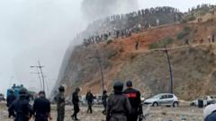 Watch: Moroccan police clash with migrants near border with Spain’s Ceuta