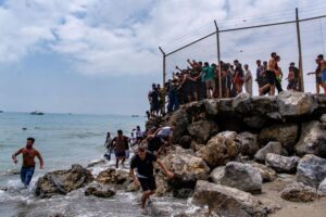 Spain’s enclave Ceuta raises alarm as thousands cross border from Morocco